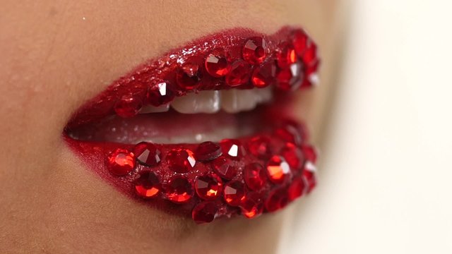 sexy woman with red rhinestones on her lips. Slow motion. close up