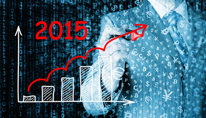 business man drawing growth graph for year 2015