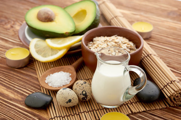 Fresh avocado on cutting board over wooden background