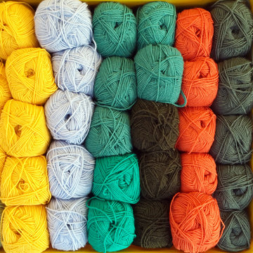 Full frame close-up of rows of different coloured balls of wool