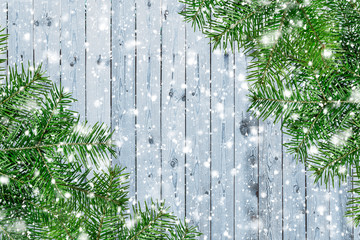 Wooden board with branches of fir. Christmas background