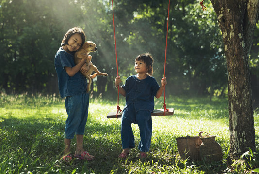 Two girls playing with their puppy dog