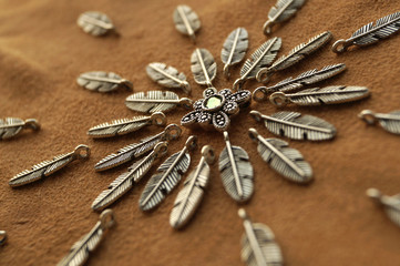 Metal beads pendants and feathers on suede