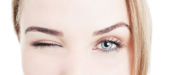 Close-up with beautiful woman eyes and wink - obrazy, fototapety, plakaty