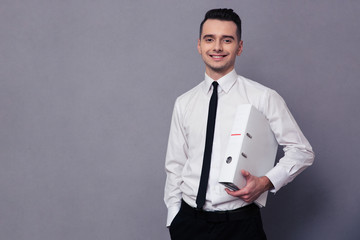 Smiling businessman holding folder