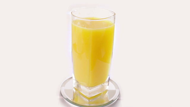 orange juice rotating on white background