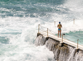Crushing waves against a ocean swimming pool