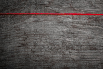 red wire on wood background - black and white single color photo