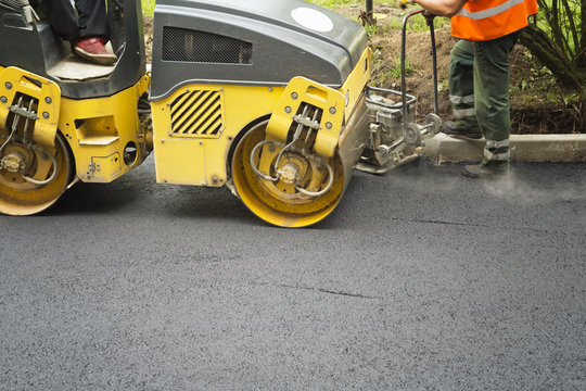 Road roller flattening new asphalt