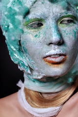 Portrait beautiful woman with creative makeup. Face mask of clay, looking like a statue