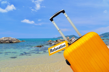 Relaxation. suitcase with label at sea.