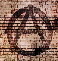 grunge anarchy symbol on old red brick wall background