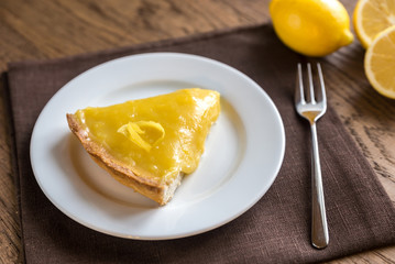 Slice of lemon tart on the plate