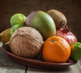 Tropical fruits: coconut, kiwi, lime, orange, mango, bananas, po