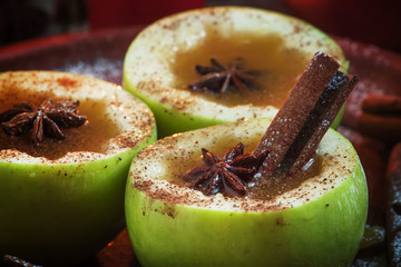 Apple cider apples in halves with cinnamon and anise, with a bur