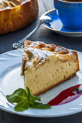 Apple pie with drop of jam on white plate