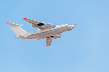 Beriev A-50 (Mainsta) Russian airborne warning and control system (AWACS) aircraft flies against blue sky background.
