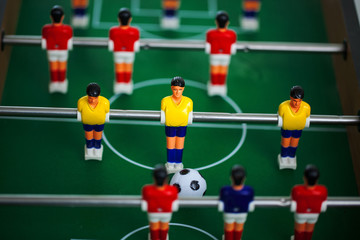 Table football game with yellow and red players