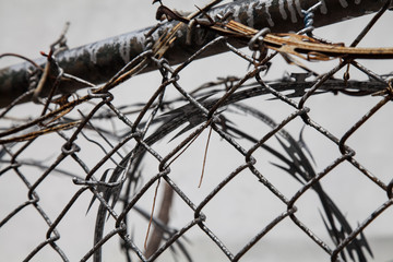 Barbed and razor wire, rusty metal fence in the city