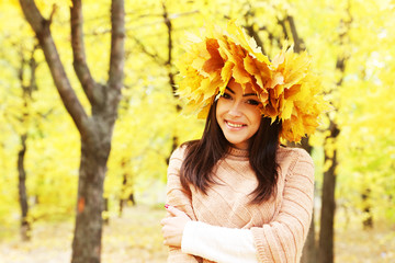 Beautiful young girl in a park in autumn, outdoors