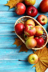 Naklejka na ściany i meble Fresh apples on a blue wooden table