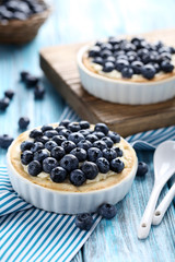 Homemade blueberry tart on blue wooden table