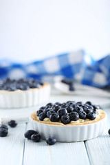 Blueberry tart on blue wooden table
