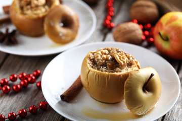 Baked apples on plate on grey wooden table