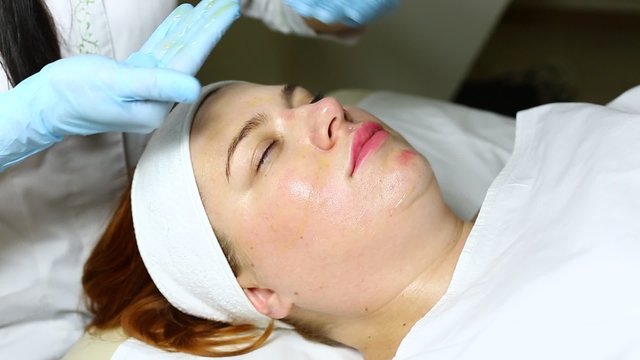 woman passes treatment mask facial at the beauty salon