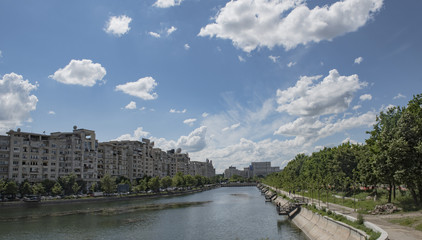 Fototapeta na wymiar Bucharest, Romania - May 07, 2015: Bucharest skyline with Dimbovita river and Parliament Palace in front
