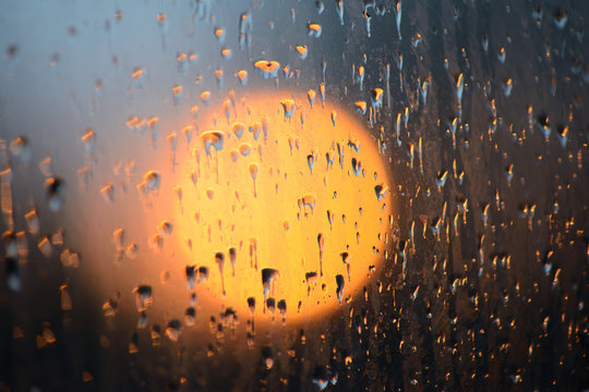 raindrops on glass at sunset
