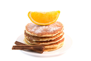 Pancakes with cinnamon and orange isolated on white background