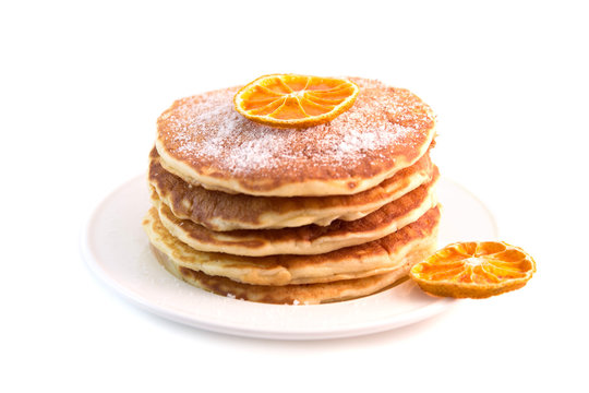 Pancakes with dried orange isolated on white background