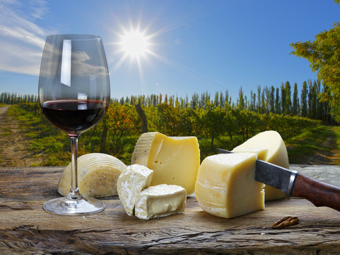 Red Wine And Cheese On The Table Outdoors