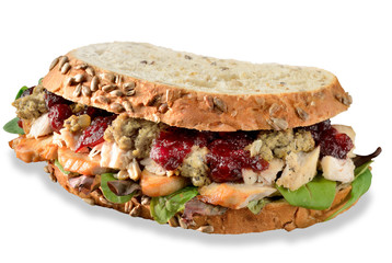 Turkey, chicken sandwich from Christmas leftovers, stuffing and cranberry sauce. Isolated