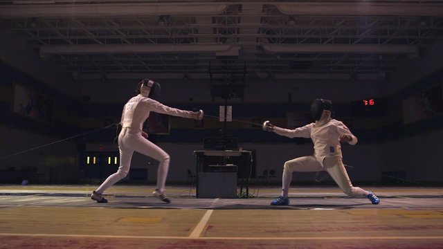 Two fencers sparring during a training session.
