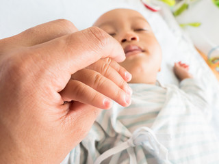  baby hand with father's hand