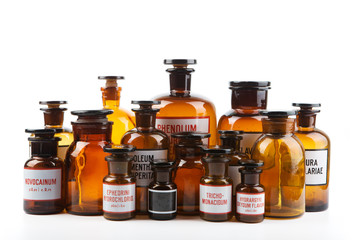 Vintage pharmacy bottles on white background