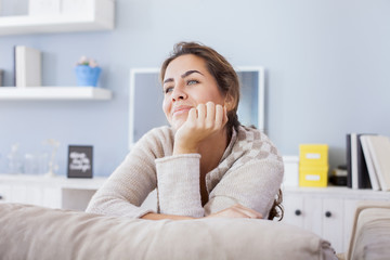 Pretty Young Woman Sitting on the Couch In the Living Room. 