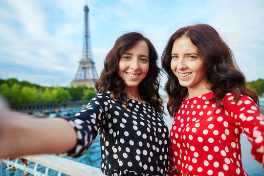 Beautiful twin sisters taking selfie