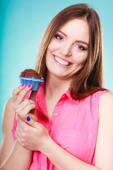 Smiling woman holds chocolate cake in hand