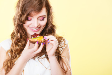 Smiling cute woman holds fruit cake in hand
