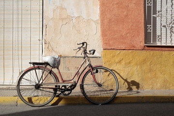 Fototapeta na wymiar Antique Bicycle parked on the street of a village 