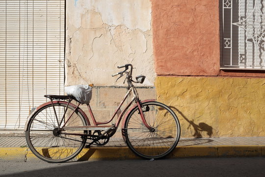 Antique Bicycle parked on the street of a village
