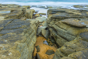 Rocks and waves at Point Cartwright beach in the afternoon. Sunshine Coast, Queensland.