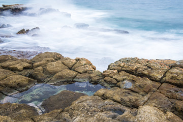 Rocks and waves at Point Cartwright beach in the afternoon. Sunshine Coast, Queensland.