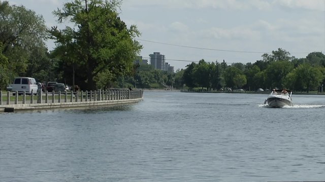Bow-rider driving through the Rideau Canal.