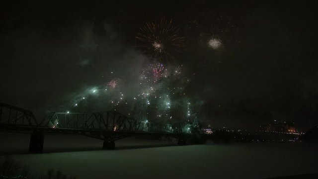 Slow motion fireworks over Alexandria Bridge crossing the Ottawa River during Winterlude.