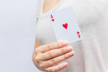 young woman holding in hand poker card with combination of Full