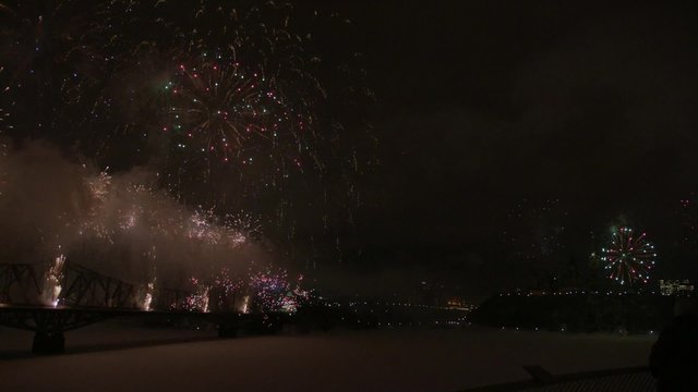 Slow motion fireworks over Alexandria Bridge crossing the Ottawa River during Winterlude.